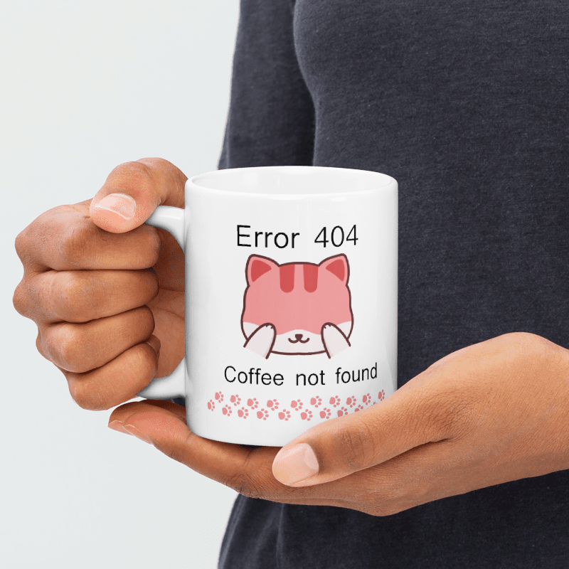 "Taza de cerámica con mensaje humorístico 'Error 404 Coffee Not Found' y dibujo de un gato sorprendido